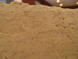 closeup of crumbs embedded in cake frosting